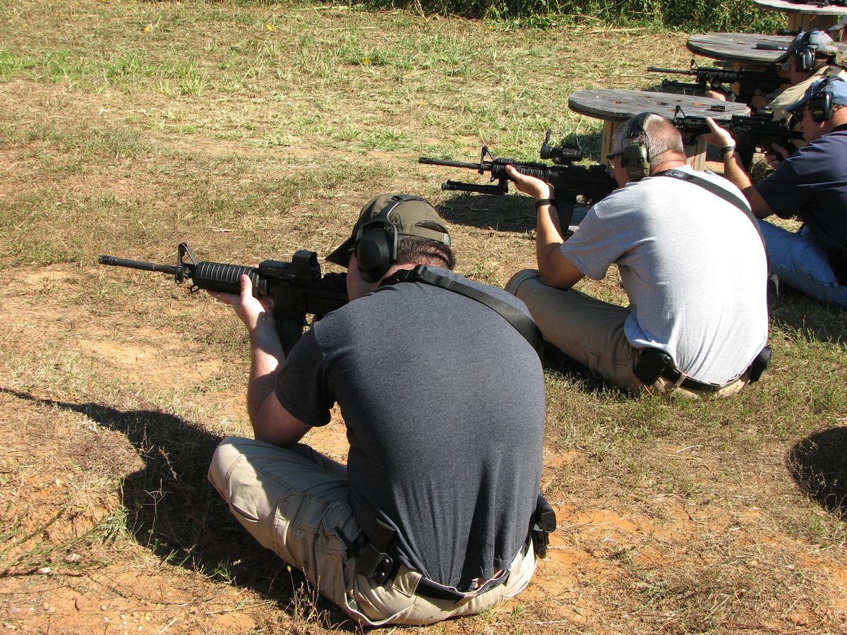Carbine class students practicing the sitting shooting position during warm-up drills