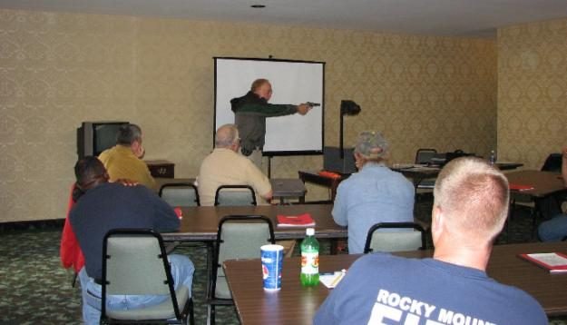 Chris Raper demonstrates drawing a handgun from concealment with proper grip and stance
